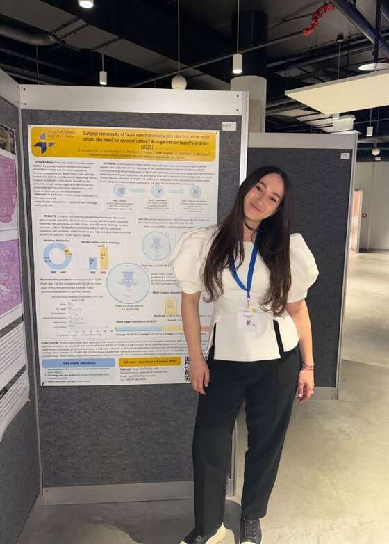 Yaroslava-Mariia Rishko beside a scientific poster at EADO 2026